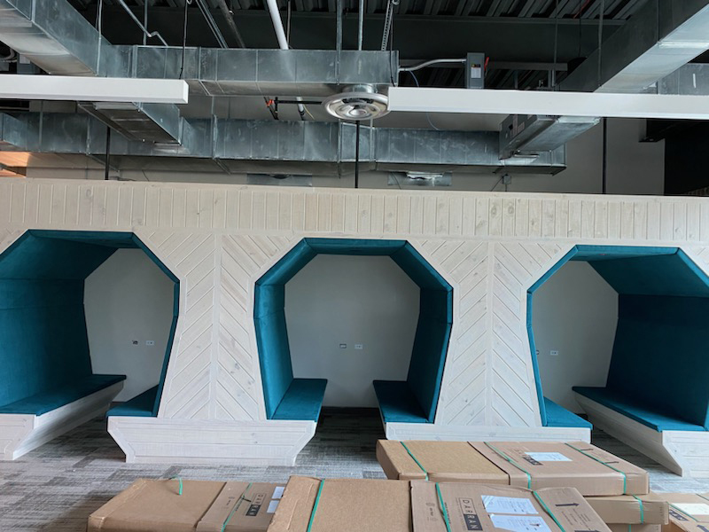 AB457766-_800px Modern teal booth seating in unfinished office space.